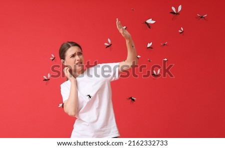 Young woman and many mosquitoes on red background