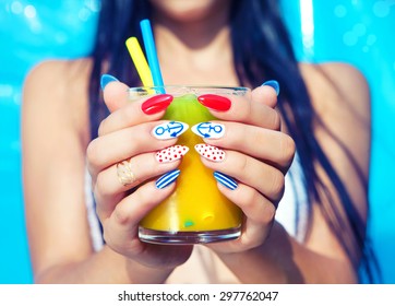 Young Woman With Marine Sailor Manicure Holding Glass Of Orange Juice, Summer Nail Art Beauty And Drink Concept