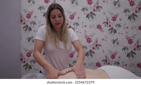 Young woman massaging elderly woman_s back. Physiotherapist providing relaxing massage therapy to senior person, health and wellbeing concept - Powered by Shutterstock