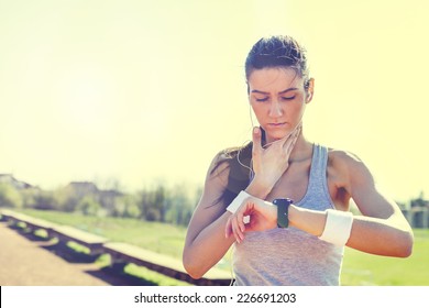 Young Woman Measuring Heart Rate After Running 