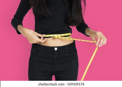 Young Woman Measuring Her Waist With Tape