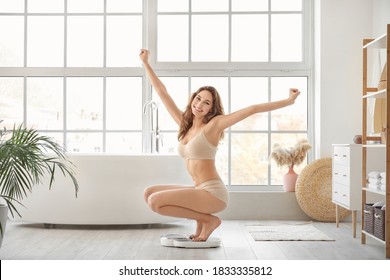 Young Woman Measuring Her Weight At Home