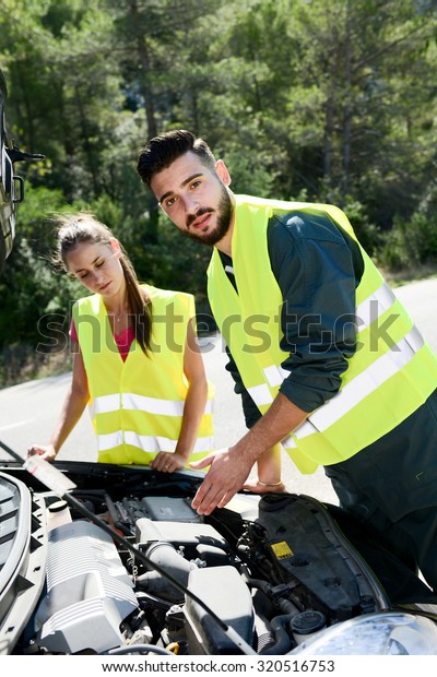 young woman and mechanic assistance on roadside\
with car breakdown