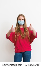 Young Woman In Medical Mask Showing Thumbs Up Isolated On White