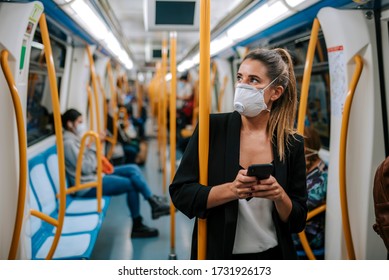 Young Woman With Medical Mask In The Subway Uses Her Phone