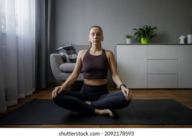 Young Woman Meditating At Home In Winter.