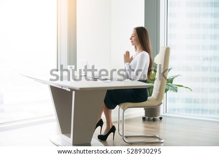 young woman meditating modern office desk の写真素材 今すぐ編集