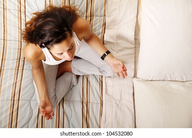 A Young Woman Meditating On The Bed.