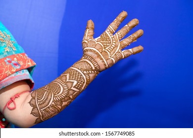 Young Woman Mehendi Artist Painting Henna On Bride's Hand Before Wedding Day