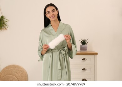 Young woman with menstrual pad at home