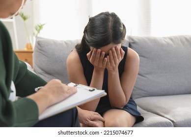 Young woman in a mental therapy session talking with a psychologist in the office. - Shutterstock ID 2215074677
