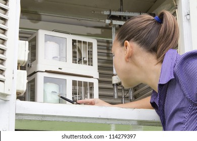 Young Woman Meteorologist Reading Meteo Instruments In Traditional Meteorologic Observation House