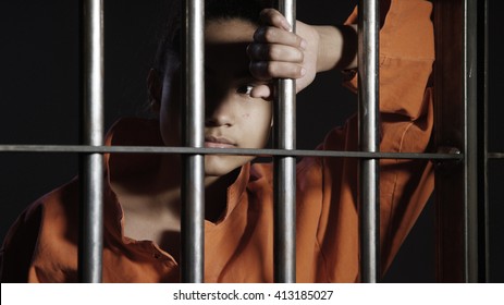 Young Woman - Minority In Prison Behind Bars