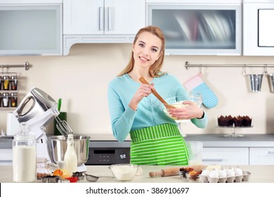 Young Woman Mixing Dough In A Bowl