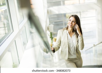 Young woman with mobile phone in the office