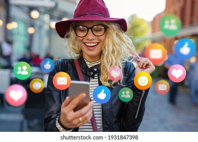 Young woman with mobile phone outdoors, concept of everyday technology usage - Shutterstock ID 1931847398