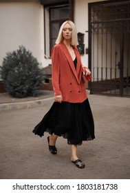 Young Woman Model In A Red Jacket And Black Dress On The Street, Fashion Photography, Street Style.