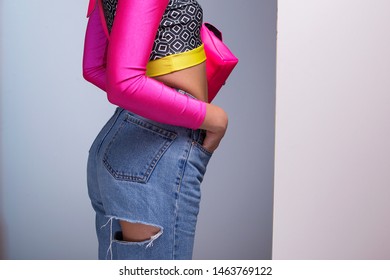 Young Woman Model Wearing Ripped Jeans And Colorful Top, 80s Fashion Look Outfit Details