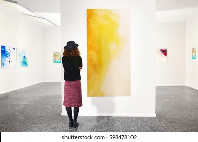Young woman in modern art gallery