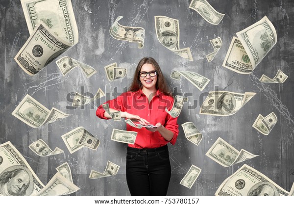 Young woman with\
money on grey background