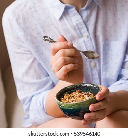 Young Woman With Muesli Bowl. Girl Eating Breakfast Cereals With Nuts, Pumpkin Seeds, Oats And Yogurt In Bowl. Girl Holding Homemade Granola. Healthy Snack Or Breakfast In The Morning.