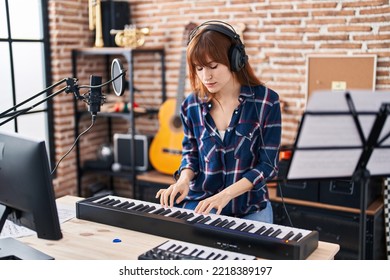 Young woman musician playing piano keyboard at music studio - Powered by Shutterstock