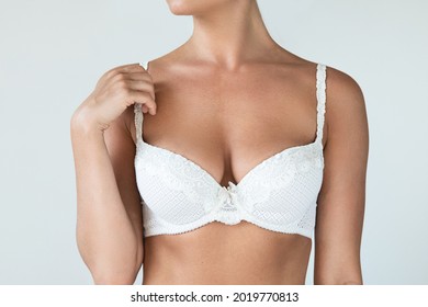 Young woman with natural breast wearing white bra