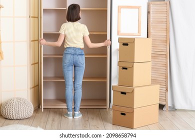 Young Woman Near Empty Wardrobe At Home