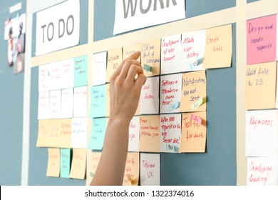 Young woman near scrum task board in office - Shutterstock ID 1322374016