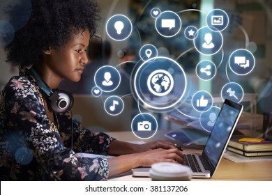 Young woman networking on social media concept with holographic icons projected from screen - Powered by Shutterstock