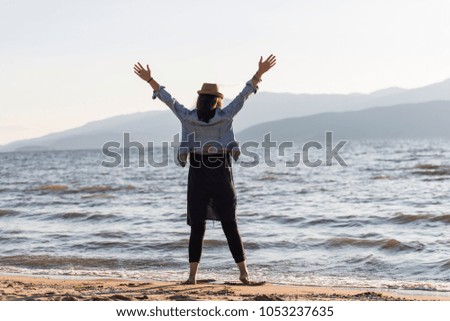 A young woman next to the peaceful waters of a lake. 