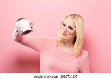 Young Woman With No More Coffee In Her Empty Mug