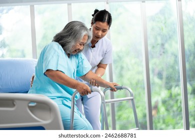 Young woman nurse helping senior elderly woman physical therapy walk with crutches. Physiotherapist, Rehabilitation Doctor, knee and leg problem in older people. - Powered by Shutterstock