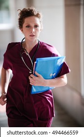 Young Woman Nurse Running In Scrubs