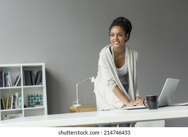 Young woman in the office - Shutterstock ID 214746433