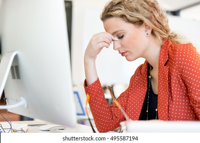 Young Woman In Office Tired