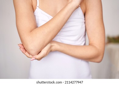 Young woman at office. Tired elbow. Female stress lifestyle. New normal education. Sad emotion. Ache concept. Pretty person. Exhausted worker pain - Shutterstock ID 2114277947