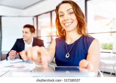 Young woman in office using tablet - Shutterstock ID 517180537