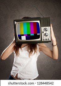 young woman with old retro television on her head