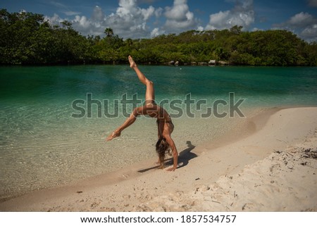 Young woman on the beach. Amazing caribbean sea. Super clean water. 