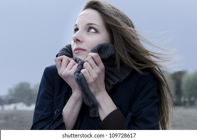 Young woman on the beach during a windy day