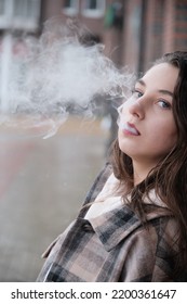 Young Woman On City Street Exhale Smoke Closeup Portrait