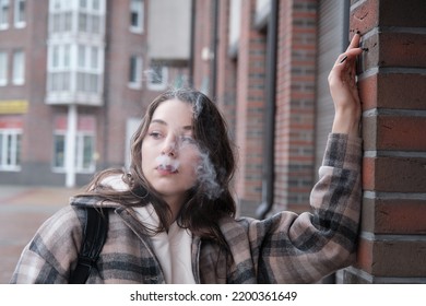 Young Woman On City Street Exhale Smoke Closeup Portrait