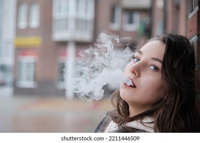 Young Woman On City Street Exhale Smoke Closeup Portrait