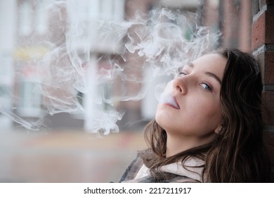 Young Woman On City Street Exhale Smoke Closeup Portrait