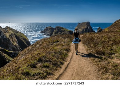 Young Woman On Coastal Hiking Path With Spectacular Cliffs At Peninsula Pointe Du Van On Cap Sizun At The Finistere Atlantic Coast In Brittany, France - Powered by Shutterstock