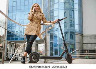 Young Woman On Electro Scooter In City.