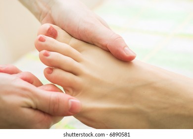 young woman on the feet therapy massage procedure - Shutterstock ID 6890581