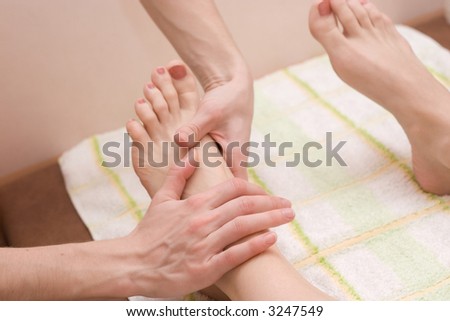 young woman on the feet therapy massage procedure