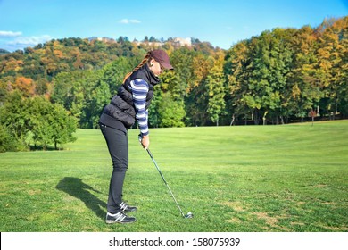 Young Woman On A Golf Course On A Sunny Autumn Day In The Background Of The Old Castle